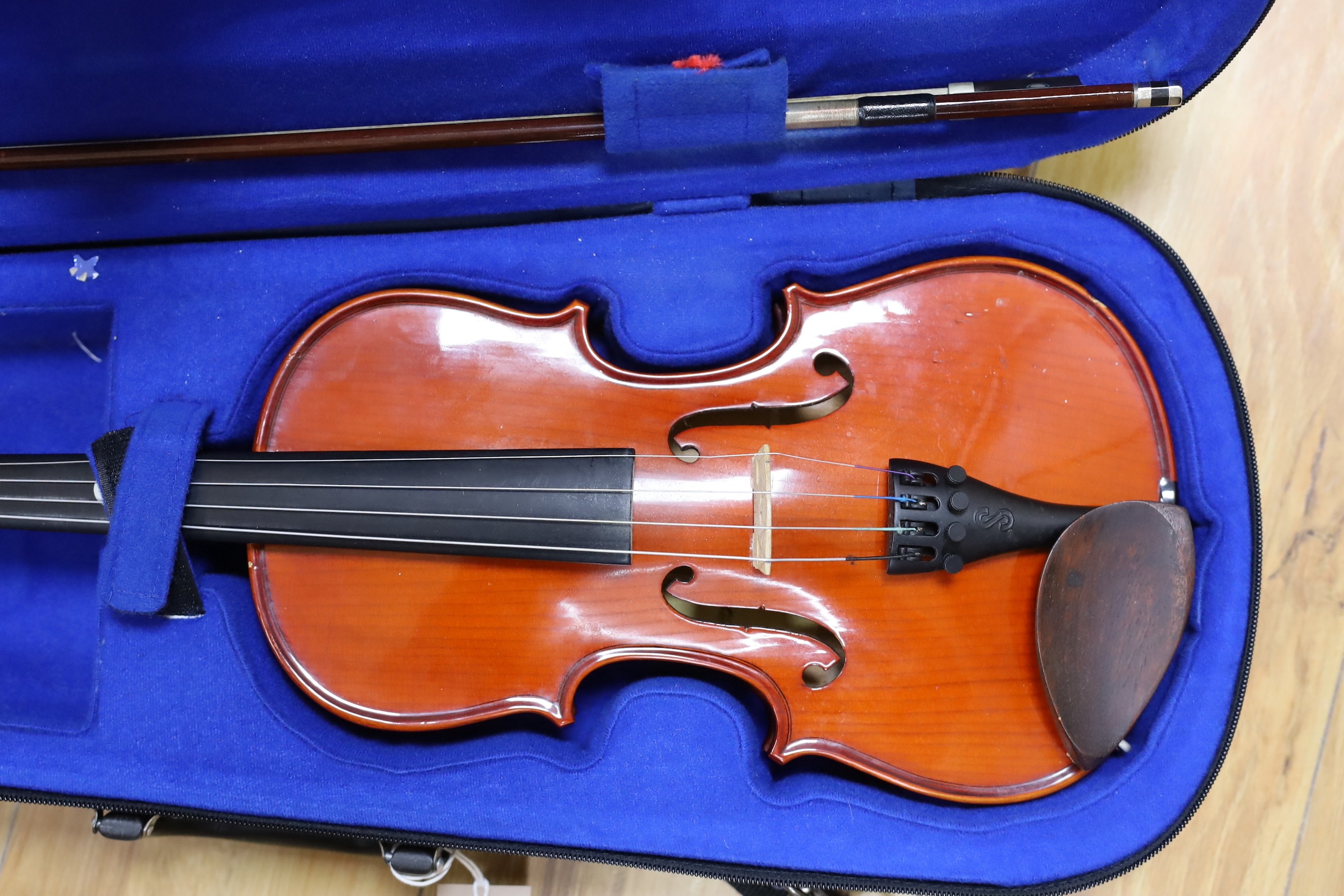 A cased violin and bow
